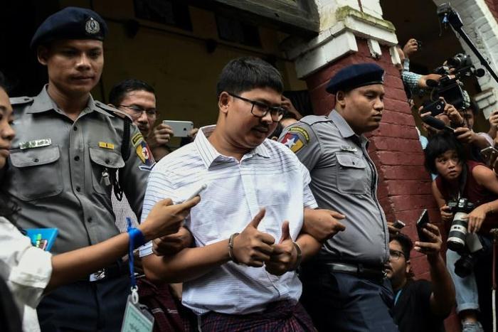 Wa Lone (C, pictured after an August court appearance) and fellow reporter Kyaw Soe Oo have already spent more than a year behind bars