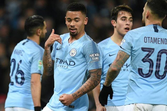 Cloud nine: Gabriel Jesus (2nd left) scored four of Manchester City's goals in a 9-0 thrashing of Burton Albion on Wednesday