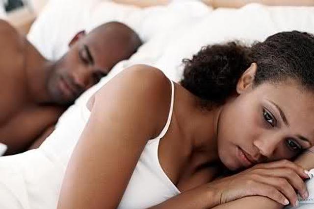 Unhappy woman in bed