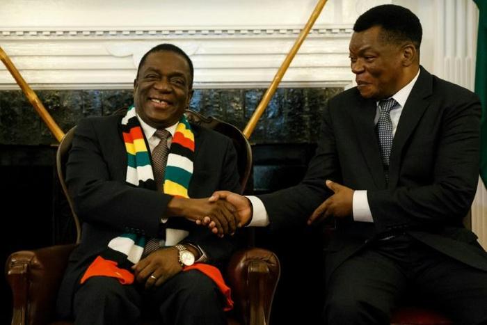 Zimbabwe President Emmerson Mnangagwa, seen here shaking hands with the newly-appointed prosecutor general Kumbirai Hodzi, has pledged to investigate any misconduct by the security forces