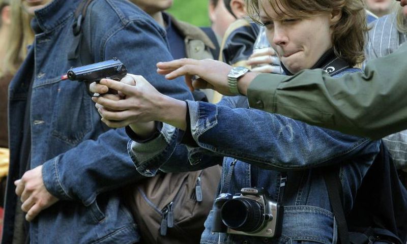 Russia's Soviet-era Makarov pistols, seen here being tried out by journalists at a Moscow weapons shop, has long been used by police and the army