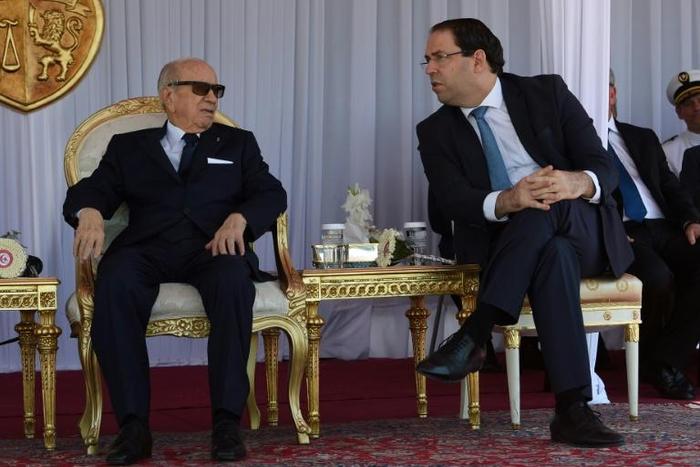 Tunisian President Beji Caid Essebsi (L) and Prime Minister Youssef Chahed attend the Tunisian naval forces military intervention drill on June 25, 2018