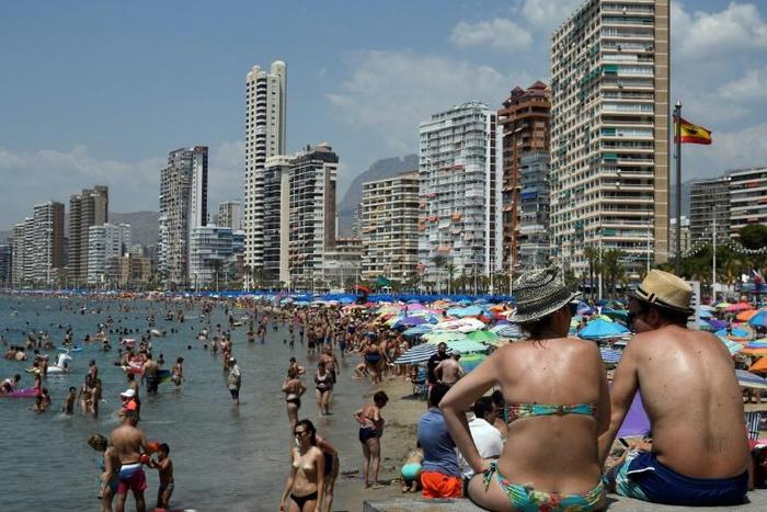 In the resort of Benidorm, pubs and English ads for mobility scooters for the elderly abound