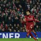 Liverpool's Egyptian midfielder Mohamed Salah (R) shoots to score their second goal from the penalty spot during the English Premier League football match between Liverpool and Newcastle United at Anfield in Liverpool, north west England on December 26...