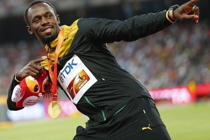 Usain Bolt of Jamaica, gold medal, reacts as he poses on the podium after the men's 200 metres event during the 15th IAAF World Championships at the National Stadium in Beijing, China, August 28, 2015.  REUTERS/Damir Sagolj