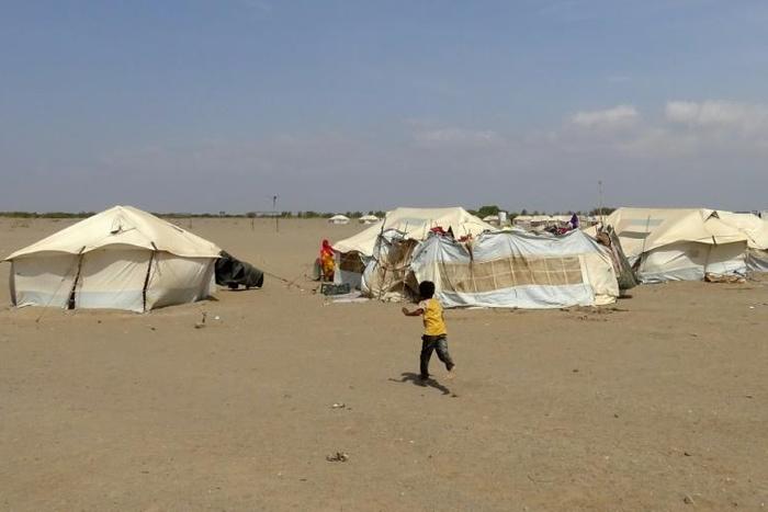 In this file photo, a Yemeni child runs toward a tent at a camp for displaced people in the Khokha district of Hodeida province on December 11, 2018