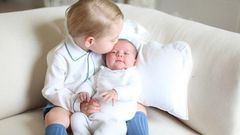 Prince George kisses his sister, Princess Charlotte on her forehead