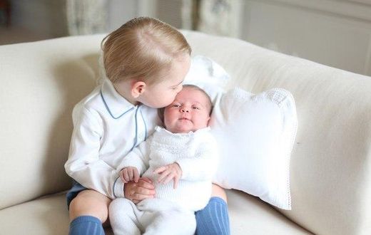 Prince George kisses his sister, Princess Charlotte on her forehead