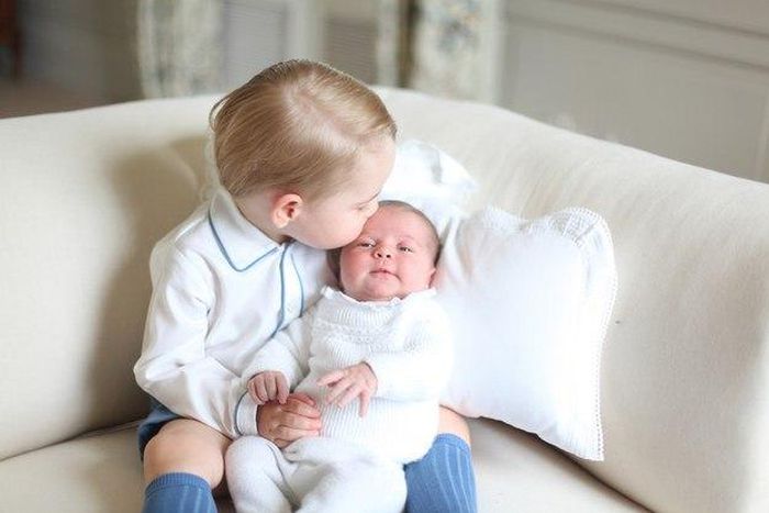 Prince George kisses his sister, Princess Charlotte on her forehead