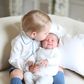 Prince George kisses his sister, Princess Charlotte on her forehead