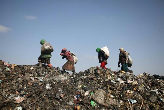 Children scour the dump near Kafr Lusin camp in search of plastic and other things they can sell to buy food