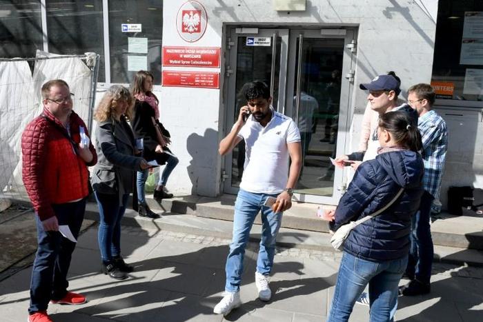 To keep its economy growing, Poland is banking on foreign workers, such as these people seeking work and residency permits in central Warsaw