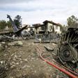 Firefighters and security forces gather at the crash site of a Boeing 707 cargo plane that slammed into a residential complex near the Iranian capital Tehran with at least 10 people onboard on January 14, 2019