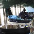 A child sick with malaria and from malnutrition lies on a bed in a hospital in Bor March 15, 2014. REUTERS/Andreea Campeanu