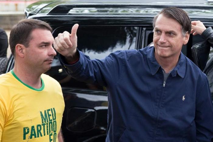 Flavio Bolsonaro (L), pictured with his father Brazilian President Jair Bolsonaro, is under growing scrutiny by a government financial watchdog