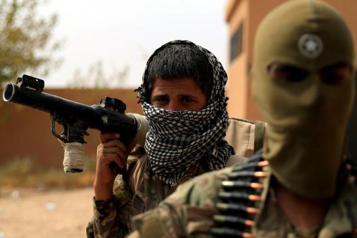 Kurdish-led fighters have overrun the last village held by the Islamic State group in Syria, confining its once vast cross-border "caliphate" to two small hamlets on the north bank of the Euphrates river