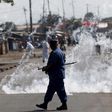 A policeman walks after throwing a teargas canister during a protest against Burundi President Pierre Nkurunziza and his bid for a third term in Bujumbura, Burundi, June 2, 2015. REUTERS/Goran Tomasevic