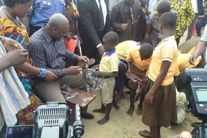 President Mahama distributing sandals to students