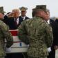 President Donald Trump salutes as the remains of one of four Americans killed in Manbij is returned to the US
