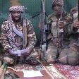 Boko Haram leader Abubakar Shekau [with a book], flanked by his men