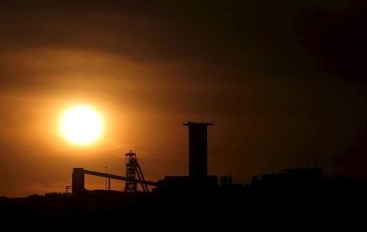 The sun sets behind a shaft outside the mining town of Carletonville, west of Johannesburg, July 7 2015. REUTERS/Siphiwe Sibeko