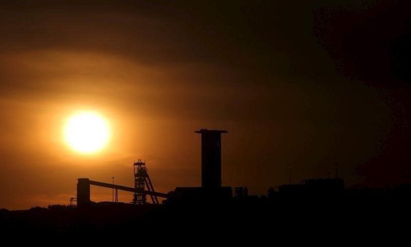 The sun sets behind a shaft outside the mining town of Carletonville, west of Johannesburg, July 7 2015. REUTERS/Siphiwe Sibeko