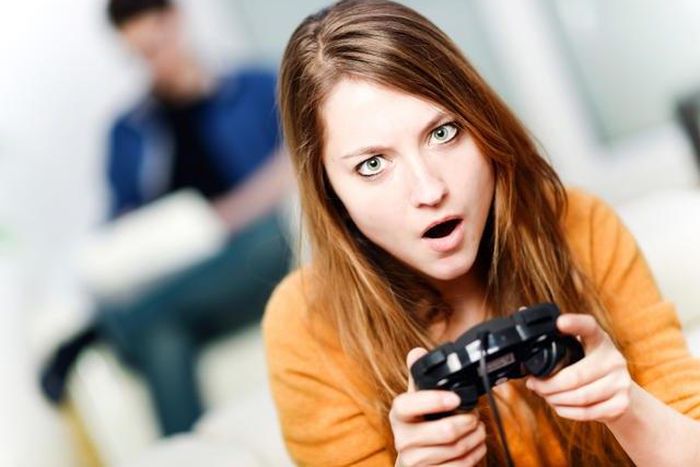 A young woman playing a video game.