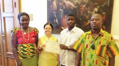 An official of the Santa Lucia education directorate (second left) presenting a certificate of merit to Master Emmanuel Sarpong Agyemang. Flanking them are the parents of Master Agyemang