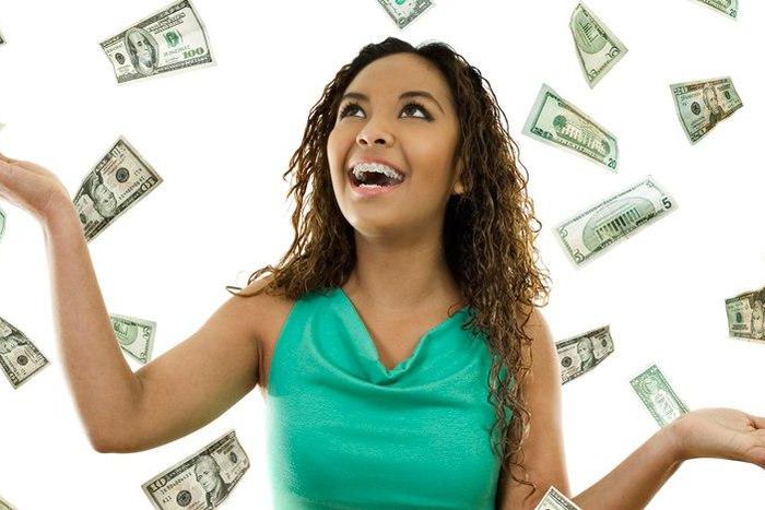 Young woman with money (File Photo)