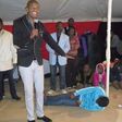 South African Pastor during prayers with the young man on the floor
