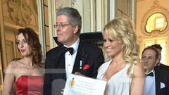 Pamela Anderson showing off her certificate of honour