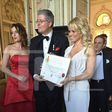 Pamela Anderson showing off her certificate of honour