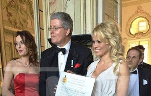 Pamela Anderson showing off her certificate of honour