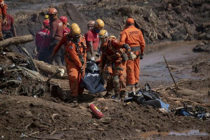 The task of recovering the bodies requires men digging down, often by hand, into mud up to 15 meters (50 feet deep), pulling out corpses that are bagged then airlifted away by helicopter