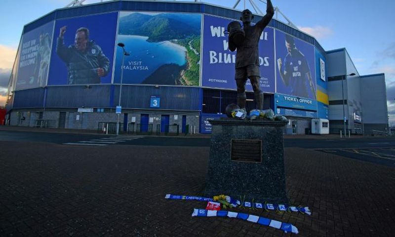 Bunches of daffodils and a scarf are left outside the Cardiff City Stadium with the club's record signing Emiliano Sala feared dead in a plane crash