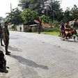 Members of Muslim rebel group Moro Islamic Liberation Front stand guard in the town of Sultan Kudarat ahead of the surrender of combatants with their firearms to President Benigno Aquino III