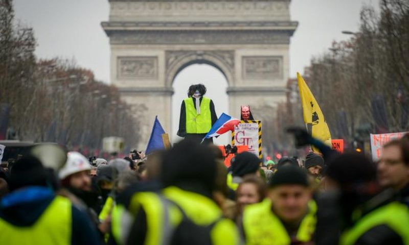 Hundreds of 'yellow vest' protesters took to the Champs-Elysees on Saturday