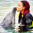 Tonto Dikeh kissing a dolphin