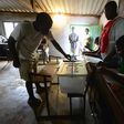 A man casts his ballot at a voting station in a file photo. REUTERS/Grant Lee Neuenburg