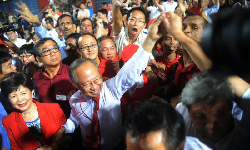 Singaporean presidential candidate Tan Cheng Bock (2nd-L) greeting his supporters in 2011 when he stood as candidate of the presidential elections in Singapore
