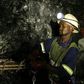 Mine workers is seend underground in Modderfontein east mine, outside Johannesburg, February 3, 2009.  South Africa's junior miner Aflease Gold said on Tuesday it aims to produce 500,000 ounces of the precious metal per year in five years based on the ...