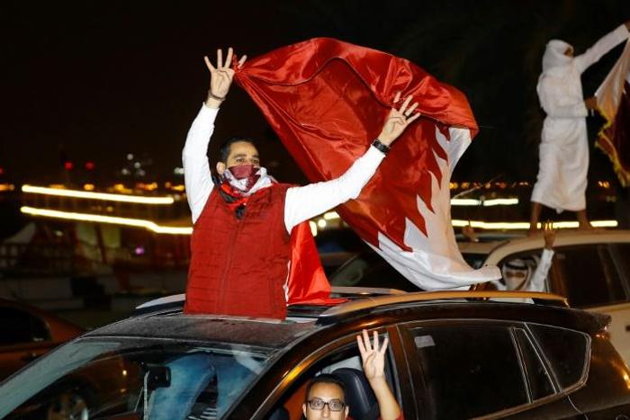 Qatari fans celebrate after their national team's victory over UAE to reach the Asian Cup final