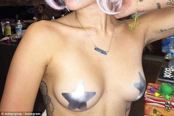 Miley Cyrus shows off her assets....barely covered!!!!