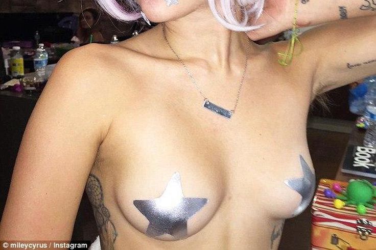 Miley Cyrus shows off her assets....barely covered!!!!