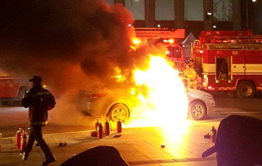 Photo by eyewitness Lee Sang-ho shows a burning taxi as a driver commits suicide near the US embassy in Seoul