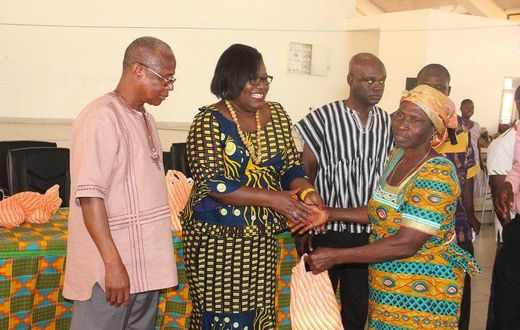  Nana Oye Lithur  presenting items and free NHIS card to an elderly woman