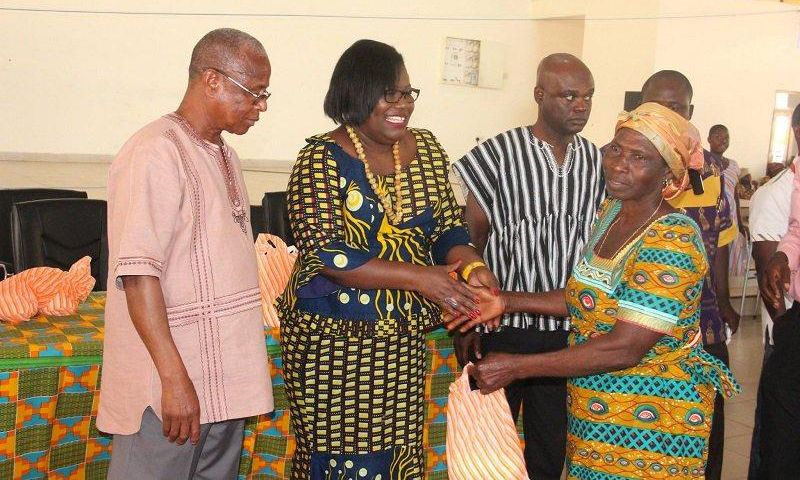  Nana Oye Lithur  presenting items and free NHIS card to an elderly woman