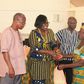  Nana Oye Lithur  presenting items and free NHIS card to an elderly woman