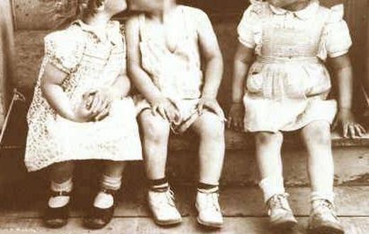 Three children act out jealous scene