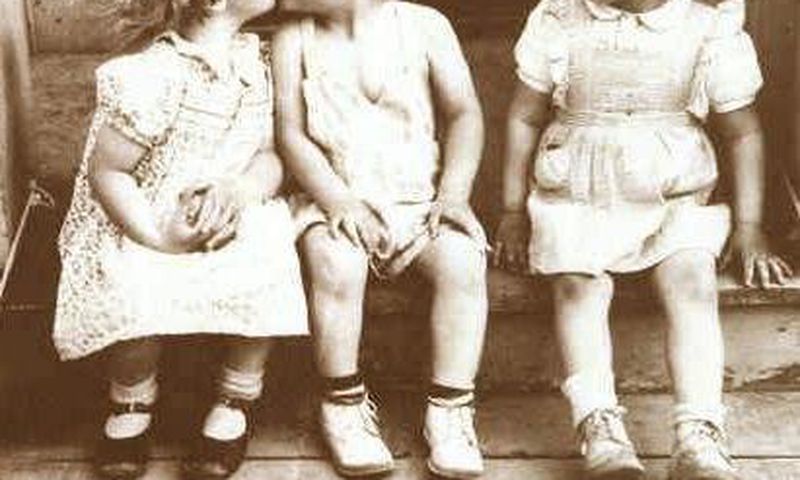Three children act out jealous scene
